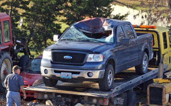 Hallsville tow-truck operator Mickey Nichols approaches the Ford F-150 that Thomas Winterhalter was driving Nov. 18 when a deer leaped from a ditch across Highway 124 and slammed into the pickup's windshield. Winterhalter was not injured.