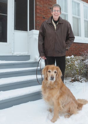 Stephenson County Board Member Jeff Mikkelsen stands at his East Jefferson Street home with family dog, Phoebe.