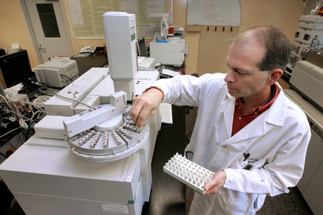 Chemist Michael Filigenzi demonstrates how vials of liquefied pet food are placed in trays for testing for the industrial chemical melamine at the California Animal Health and Food Safety Laboratory, at the University of California, Davis, campus in Davis, Calif., Monday, Nov. 18, 2008. Traces of melamine have been detected in samples of top-selling U.S infant formula.