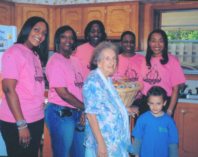 Pink Ladies distributed Thanksgiving baskets to families in need. Pictured is: Bianca Phillips, Stacey Cox, Raven Veal, Chevelle Garnett, Tracey Francis, and Josephine Escondel and her grandson Vincent.