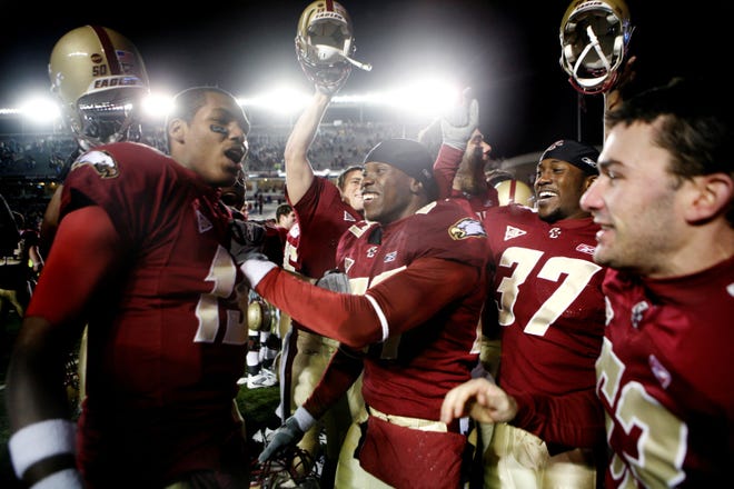 Boston College redshirt freshman quarterback Dominique Davis (left) celebrates after the Eagles beat Maryland to earn a berth in the ACC Championship Game.
