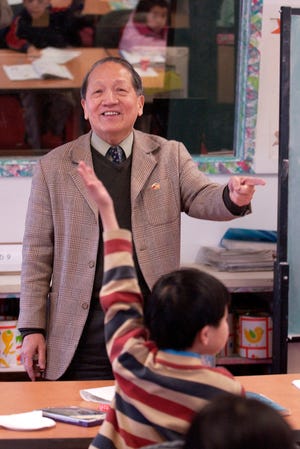 Chung Yee School headmaster Harry Kwan calls on students to write on the board in Chinese in 2006. The school has been shut down by Quincy police.