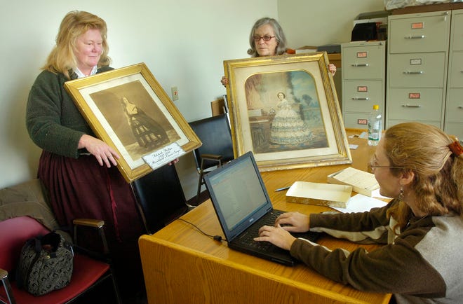 Members of the Marshfield Historical Commission inventory gifts people have given the commission through the years. Vice Chairwoman Regina Porter, left and Recording Secretary Jane Davidson display items as member Noreen Finneran compiles a list.