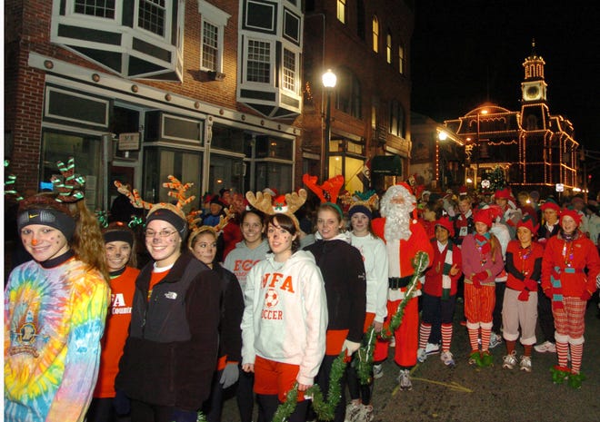 Kathleen O'Brien, 16, of Norwich, left, and other "Santa's reindeer" join over 100 runners Friday, December 5, 2008 in the annual Tommy Toy Fund Fun Run at Billy Wilson's Ageing Still in downtown Norwich..