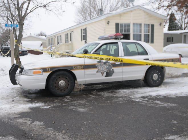 Ottawa County sheriff's deputies investigate the scene of a double shooting at Leisure Estates Sunday afternoon.