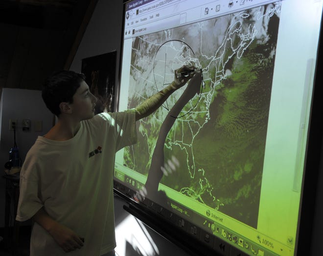 Advanced Math and Science Academy earth science student Jacob Jura of Shrewsbury uses a new interactive touchscreen Monday.