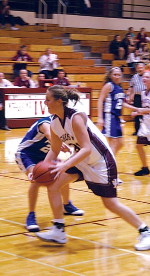 Driving to the hoop: Laci Peterson tries to score for IVC against division rival Princeton.