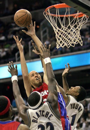 Washington Wizards' Andray Blatche and Nick Young, right, defend against Detroit Pistons' Tayshaun Prince during the second quarter of an NBA basketball game in Washington, Tuesday, Dec. 9, 2008. (AP Photo/Lawrence Jackson)