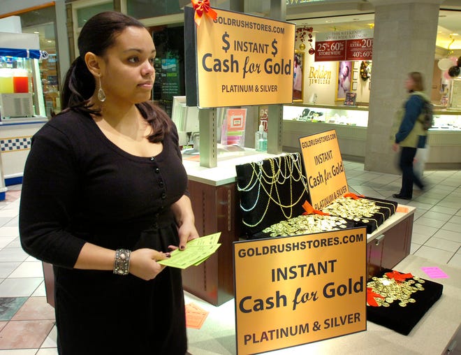 Yvette Ortiz works at the Gold Rush kiosk at South Shore Plaza in Braintree.