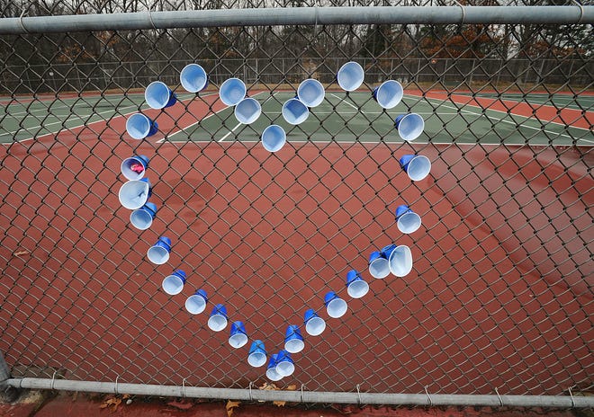 Students at Framingham High School made a heart in the chain link fence at the school's tennis courts in memory of math teacher and tennis coach Michelle Chouinard, 31, who died of cancer.