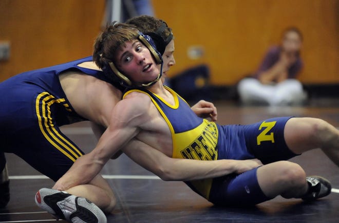 Needham’s Logan Turnbull is twisted around in a match at 125 pounds on Saturday. Against Hamilton-Wenham, Turbull had a pin as the Rockets dominated, 30-6.