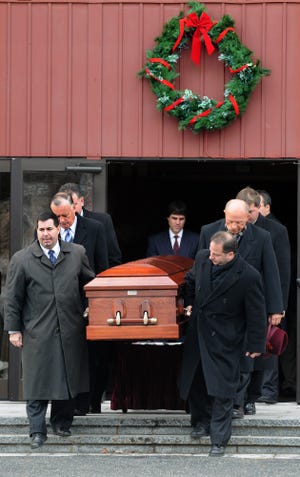 Pallbearers carry Michelle Chouinard's casket out of St. Cecilia's Church following the funeral Mass.
