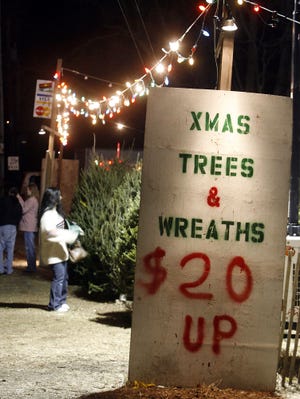 People shop for Christmas trees at Route 27 Trees in Stoughton.