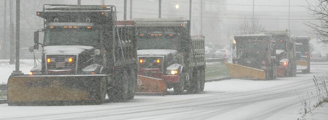 Snow plows near Rt 3 in Hanover wait to get the word to plow the highway.
