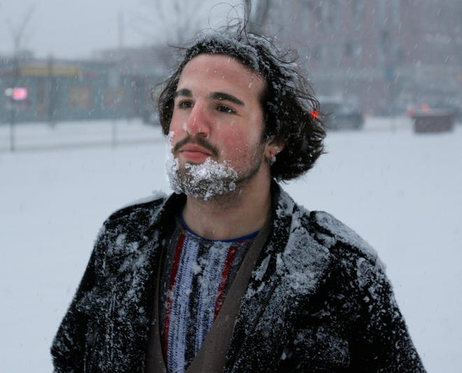 After making snow angels with his friends at Natick Common, Brendon Feak of Natick comes up with a beard full of snow during Friday.
