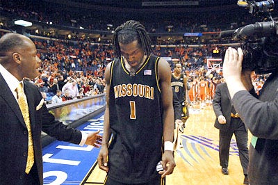 Missouri Coach Mike Anderson, left, consoles senior DeMarre Carroll center as they leave the court after a 75-59 loss to Illinois last night in the Braggin' Rights game in St. Louis. The Tigers fell behind early and could never catch up. Â?Â  See the Slide Show