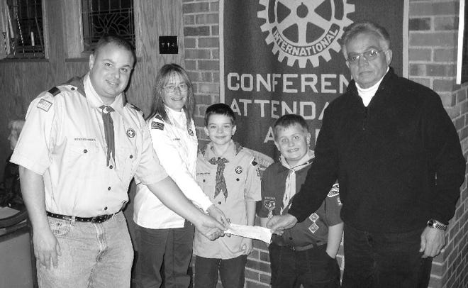 Pictured left to right: Pete Sussenbach,Wolf Den leader,Dawn Ackerman,treasurer of Cub Pack 90,Matt Akerman and Jeb Sussenbach,Scouts.Presenting the donation Vice-President of the Top-O-Pocono Rotary Club,Steve Kager