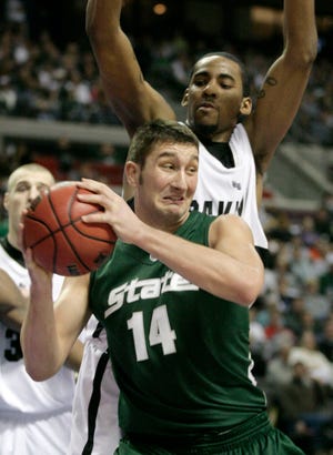 Michigan State forward Goran Suton (14) works to the basket against Oakland University center Keith Benson in the second half of an NCAA college basketball game Saturday, Dec. 27, 2008, in Auburn Hills, Mich. Suton led No. 11 Michigan State with 16 points in a 82-66 win. (AP Photo/Duane Burleson)