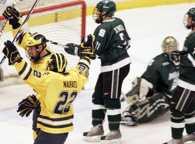 Michigan's Travis Turnbull, back left, celebrates his goal with Brandon Naurato (22) against Michigan State during the first period of a Great Lakes Invitational college hockey game Sunday, Dec. 28, 2008, in Detroit. (AP Photo/Jerry S. Mendoza)