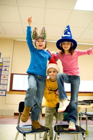 Second-graders Caroline Wyant, Ian O'Malley and Christina Alcaro get into the spirit of Crazy Hat Day.