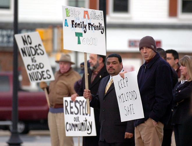 Protesters stand outside of Town Hall in opposition to the adult entertainment hearing for Doc's Sports Bar in Milford.