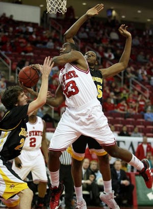 North Carolina State's Tracy Smith (23) is fouled by Towson's Brian Morris (left), as Towson's Robert Nwankwo (25) defends during the first half of an NCAA college basketball game Wednesday in Raleigh.