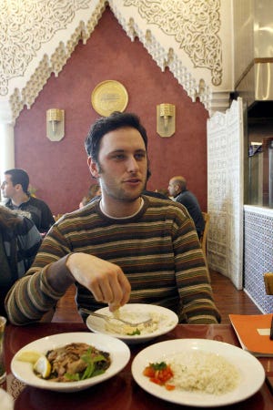Noah Galuten eats Syrian food with friends at the Sham restaurant in Santa Monica, Calif., Dec. 12.