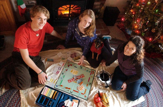 Following a tradition, Russell P. McHenry and his sister, Dakota J. McHenry, set up a game of Monopoly they plan to play tonight, as their mother, Paige E. Williar, prepares for the picnic the Mendon family will have on the living room floor. Ms. Williar’s family usually celebrates New Year’s Eve at home, but for those who want to go out, many activities and events are planned for families.