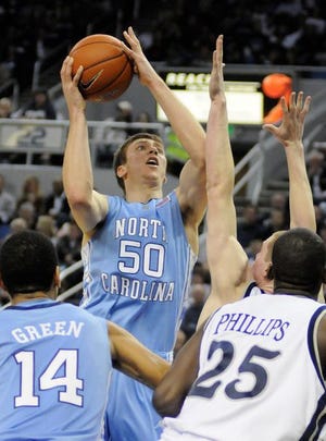 North Carolina's Tyler Hansbrough (50) attempts a shot against Nevada defender Luke Babbitt (5) during the second half of an NCAA college basketball game in Reno, Nev., on Wednesday.