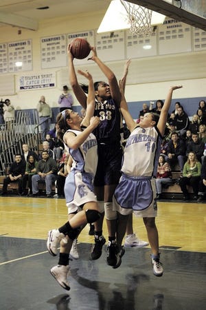 Photo by Anna Murphey/New Jersey Herald 
Pope John’s Vanessa Moore shoots over Sparta’s Casey Cresbaugh and Hanna Stimac during Saturday’s game at Sparta. Pope John won, 
58-51.