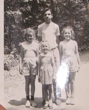 Lawrence Davis poses with his sisters in the 1950s.
