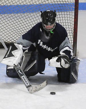 Framingham girls hockey team goalie Casey Curran makes a save during the Flyers' win over rival Natick.