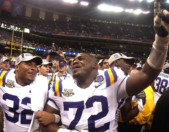 Former LSU All-American defensive tackle Glenn Dorsey, an East Ascension alum celebrates the Tigers’ National Championship victory over Ohio State with running back Charles Scott in the Louisiana Superdome Jan. 7, 2008.