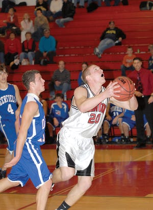 Clinton senior Steve Embry looks for his shot in front of a Deerfield defender Tuesday. Clinton won the game 69-33.