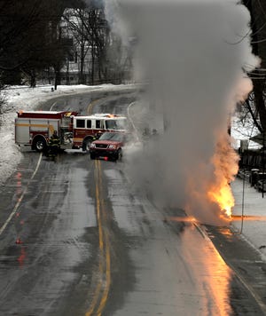 Traffic was stopped on Old Connecticut Path in Framingham at noon Wednesday when a downed 13,800 volt power line burned into the pavement. Power was knocked out to 3700 homes, but was restored within two hours, according to Assistant Fire Chief John Magri.