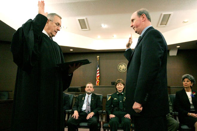 State attorney William P. Cervone is sworn into office by Chief Judge Frederick D. Smith, as fellow constitutional officers being sworn in look on, left to right, tax collector Von Fraser, Alachua County Sheriff Sadie Darnell, and Supervisor of Elections Pam Carpenter, Tuesday, January 6, 2008 at the Alachua County Family/Civil Justice Center in Gainesville, Fla.