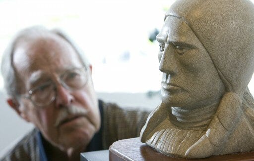 George Hanover, a member of the Ocala Art Group, puts his limestone sculpture of a Sioux Indian on display in the group’s Mid-Winter Serendipity all-member show at the Brick City Center for the Arts in Ocala on Monday.