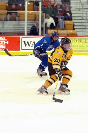 Adrian College sophomore Shawn Skelly carries the puck up ice during a MCHA?game against Finlandia in November. Skelly leads the nation in scoring and has helped the No. 9-ranked Bulldogs to an 11-1-1 record this season.