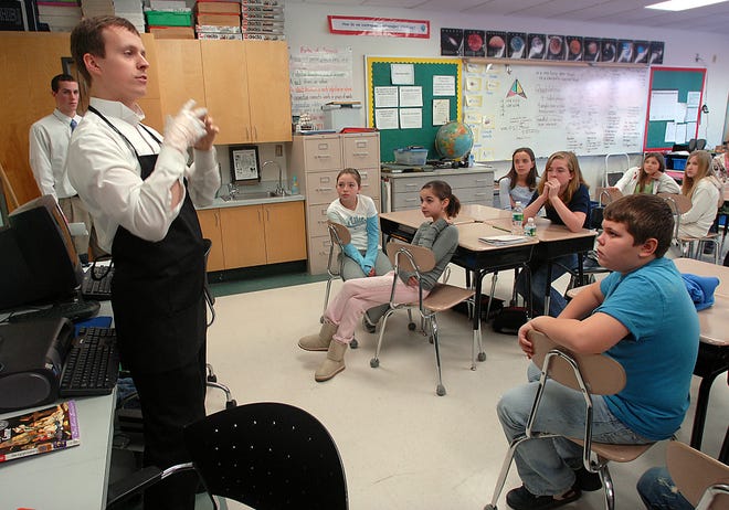Tom Ormondroyd, owner of Tom's Gourmet Marketplace in Northborough, speaks to fifth-graders at Northborough's Zeh Elementary School about customer service Friday.