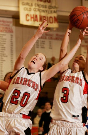 North Quincy's Kathleen Lynch and Cara Murtagh try to haul in a loose ball.