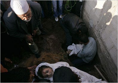 Palestinians set down the bodies of two members of the Samouni family during a funeral in Gaza City on Monday.