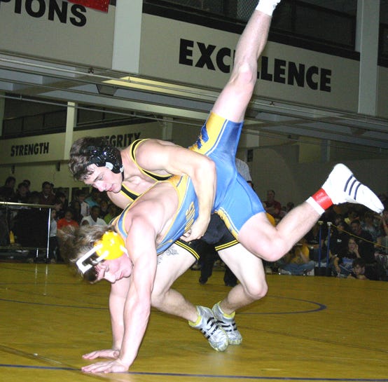 St. Amant’s Zach Eunice attempts to takedown St. Paul’s Korey Miller in the 145-pound final of the Lee Invitational Saturday evening at the Ketchum Center.