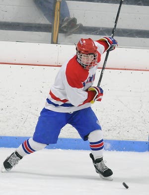 Natick's Jackson Hookway winds up for a slap shot during the Red and Blue's 4-2 loss to Chelmsford.