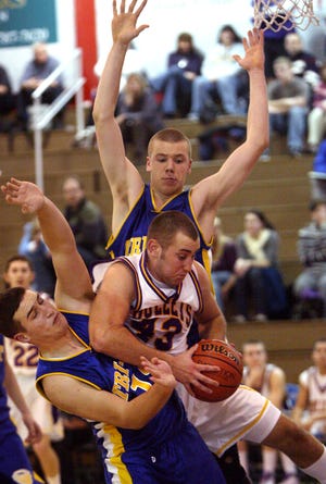 Williamsville's Travis Combs keeps a his rebound ball from Tri-City's Andrew Henton, left, and Allen Ealey Monday, Jan. 12, 2009, during the first game of the Sangamon County Boys Basketball Tournament at Lincoln Land Community College. Williamsville beat Tri-City 47-33. Shannon Kirshner/The State Journal-Register