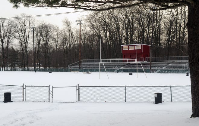 The Milford High School football field and track is covered with snow, but officials worry that as spring approaches the complex will not be fit to host track meets.