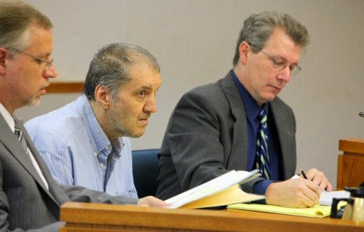 Robert Teti, center, listens to court proceedings with his defense attorneys Bill Miller, left, and Alan Bushnell during his trial at the Marion County Judicial Center in Ocala on Tuesday. Teti allegedly shot and killed a customer service manager and shot a police officer at the Kash N Karry grocery story in Belleview in April 2005. The defense says he mentally ill and thought people in the store were out to drive him crazy.