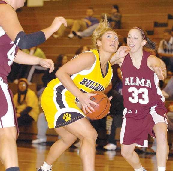 Adrian College’s Elysia Norris prepares to attempt a shot during Wednesday’s MIAA?contest against Alma. Norris and Adrian defeated the Scots 57-50.