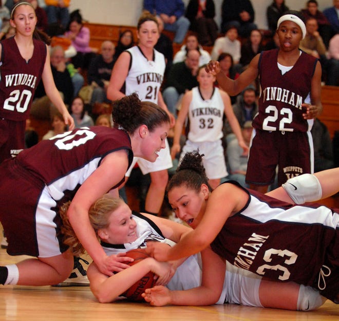 EAST LYME 1/16/2009
East Lyme's Ellie Kleinhans, center, and Windham's Amie Toner, left, and Bianca Gilda, right, fight for the ball under East Lyme's basket during a game at East Lyme High School Friday, January 16, 2009.
Tali Greener/Norwich Bulletin