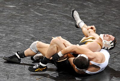 Missouri 157-pounder Michael Chandler, top, rolls Joe Cornejo in the Tigers' 33-12 victory over Missouri Valley. Chandler's victory sparked a six-match win streak.