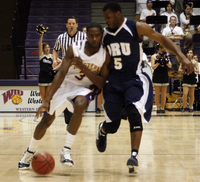 Western Illinois University freshman guard Tommie Tyler (left) works his way up the floor against Oral Roberts University's Kelvin Sango during the second half of Saturday's Summit League contest played at Western hall in Macomb. Tyler finished with 10 points and five rebounds as the Leathernecks suffered a 64-54 defeat. WIU will spend the next two weekends on the road, starting with a Thursday contest against IPFW at Fort Wayne, Ind.